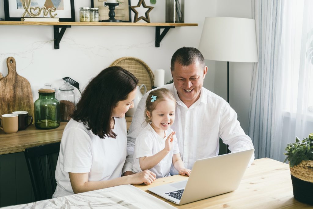 Christian family reviewing service options at home, smiling together, representing trust and values-based hiring.