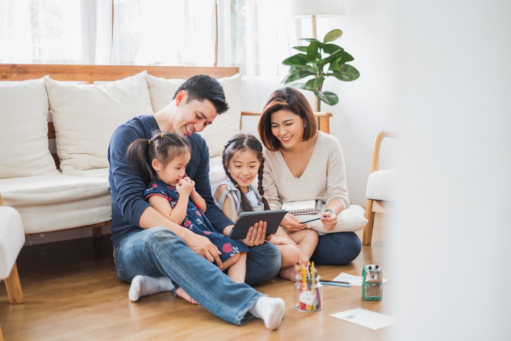 Christian family using a laptop to search for trusted local service providers through a faith-based directory.